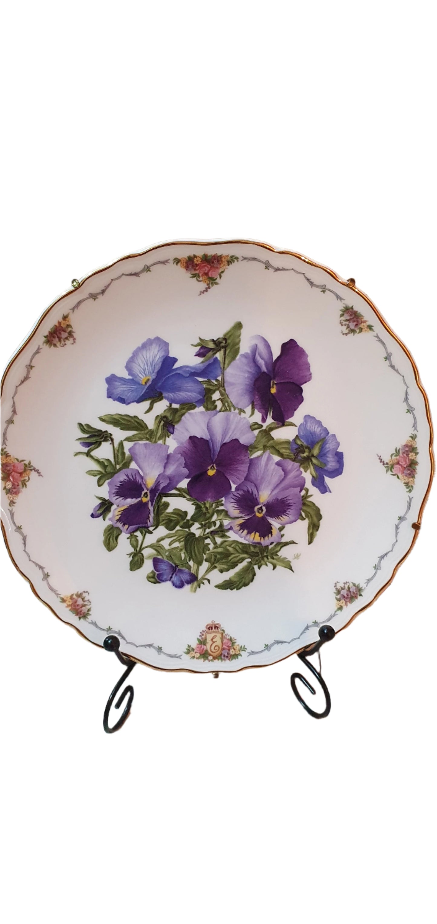 Decorative collectible porcelain plates from Royal Albert, part of "The Queen Mother's Favorite Flowers" series.