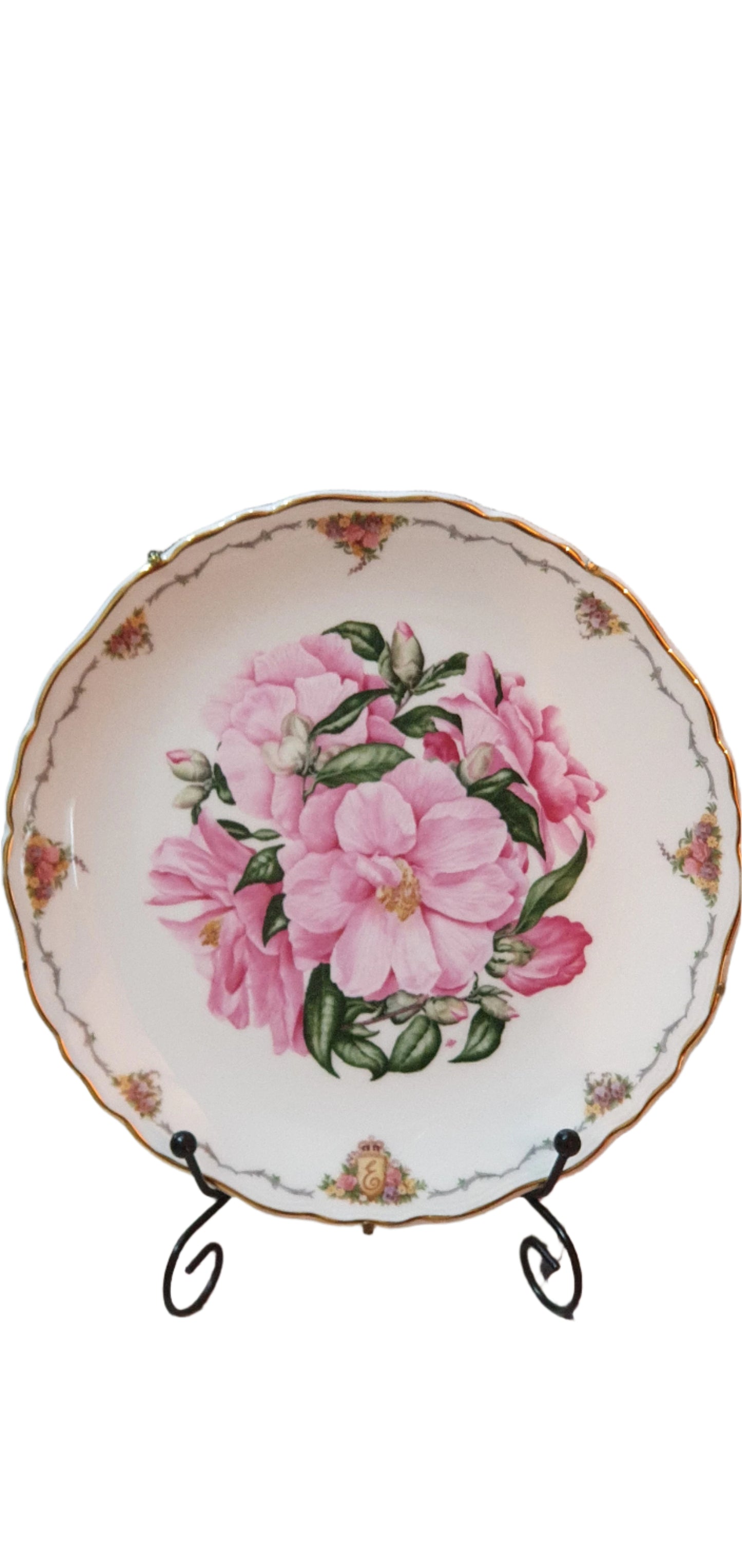 Decorative collectible porcelain plates from Royal Albert, part of "The Queen Mother's Favorite Flowers" series.