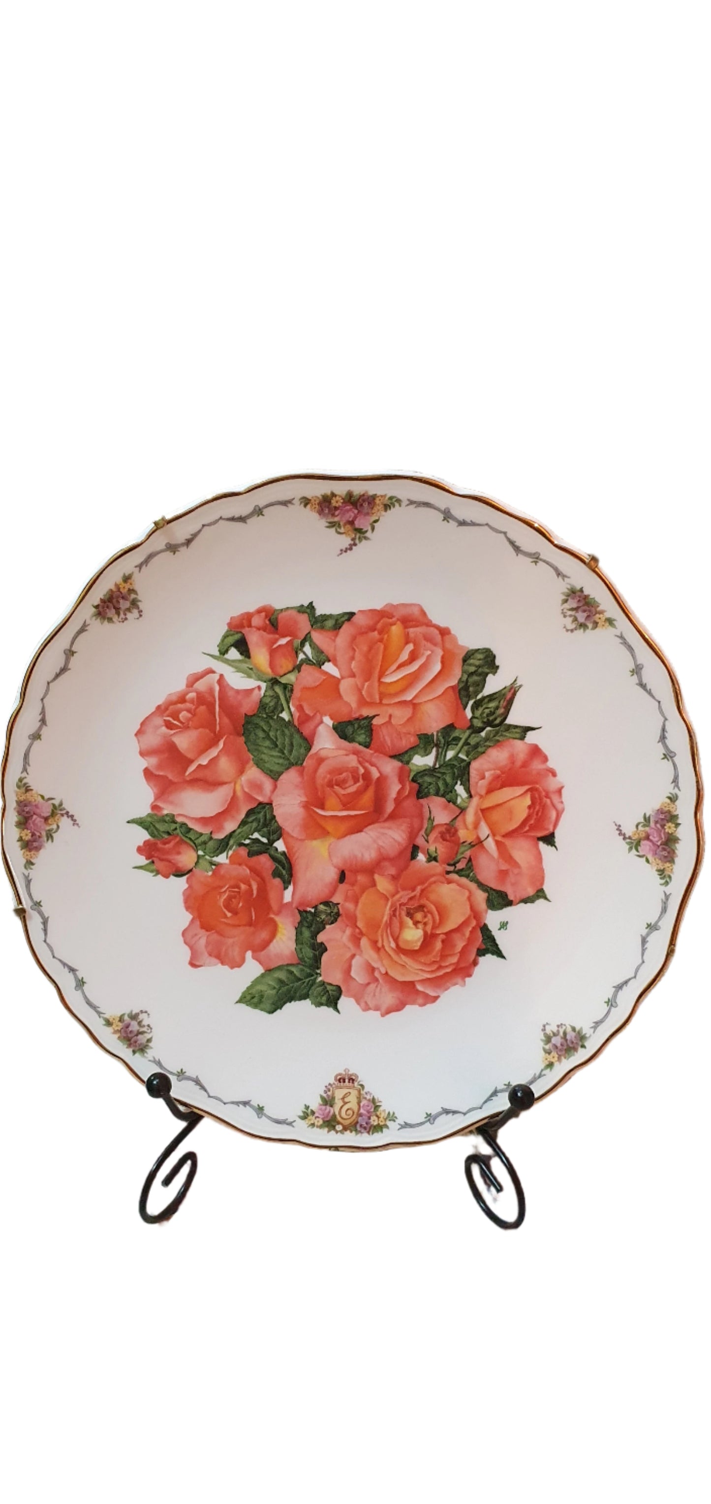 Decorative collectible porcelain plates from Royal Albert, part of "The Queen Mother's Favorite Flowers" series.