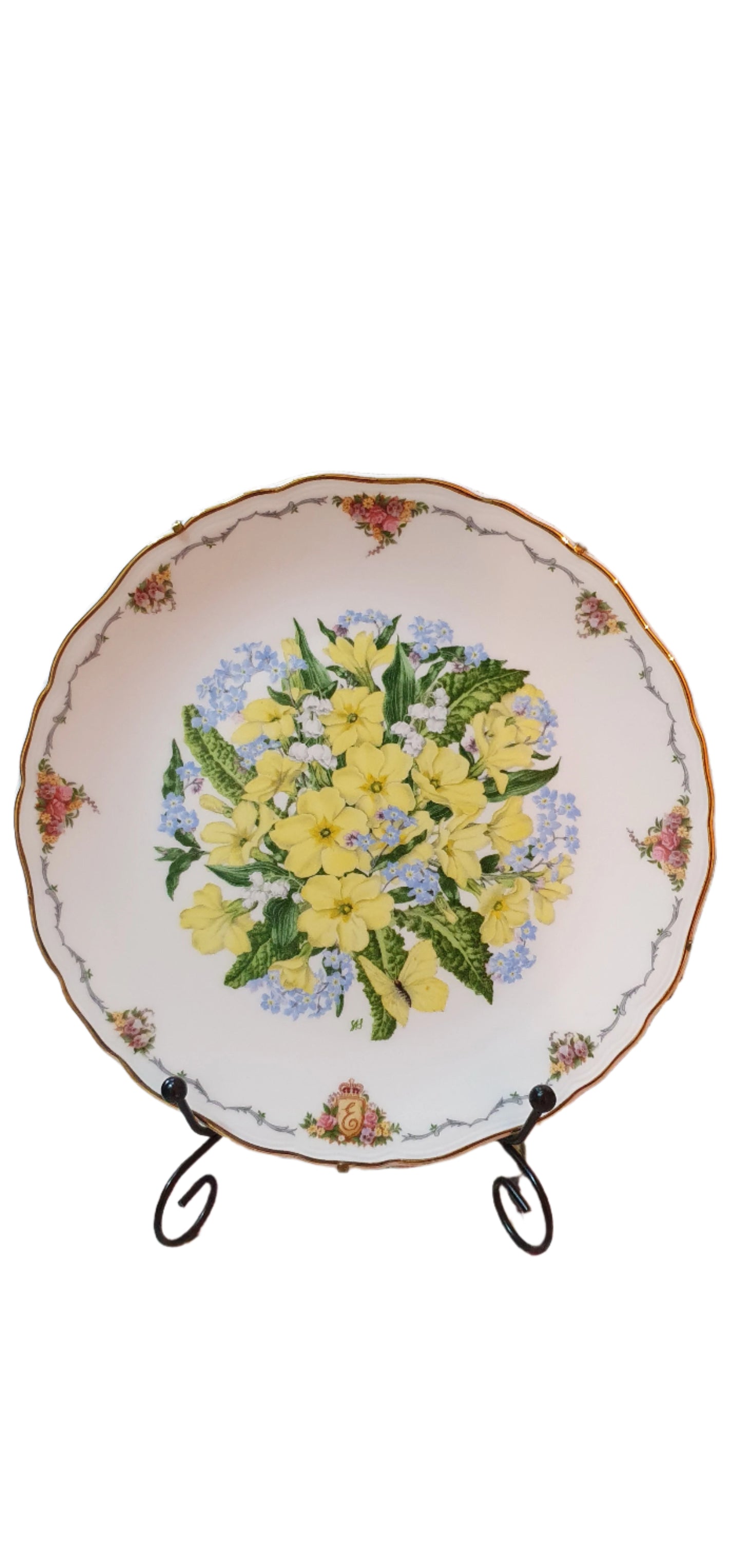 Decorative collectible porcelain plates from Royal Albert, part of "The Queen Mother's Favorite Flowers" series.