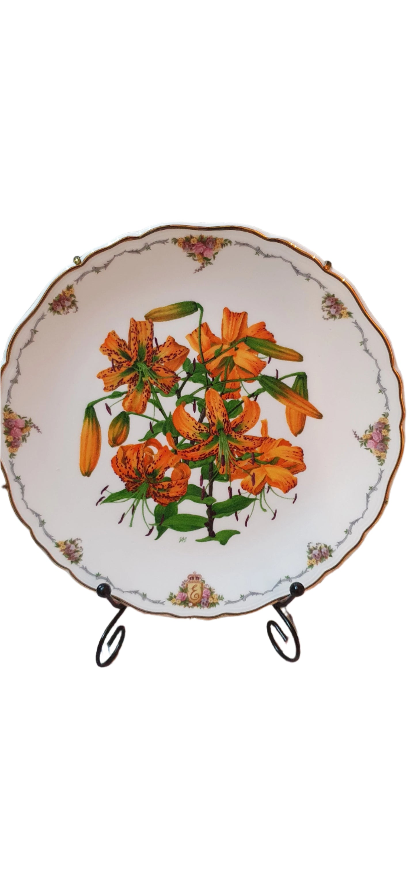 Decorative collectible porcelain plates from Royal Albert, part of "The Queen Mother's Favorite Flowers" series.
