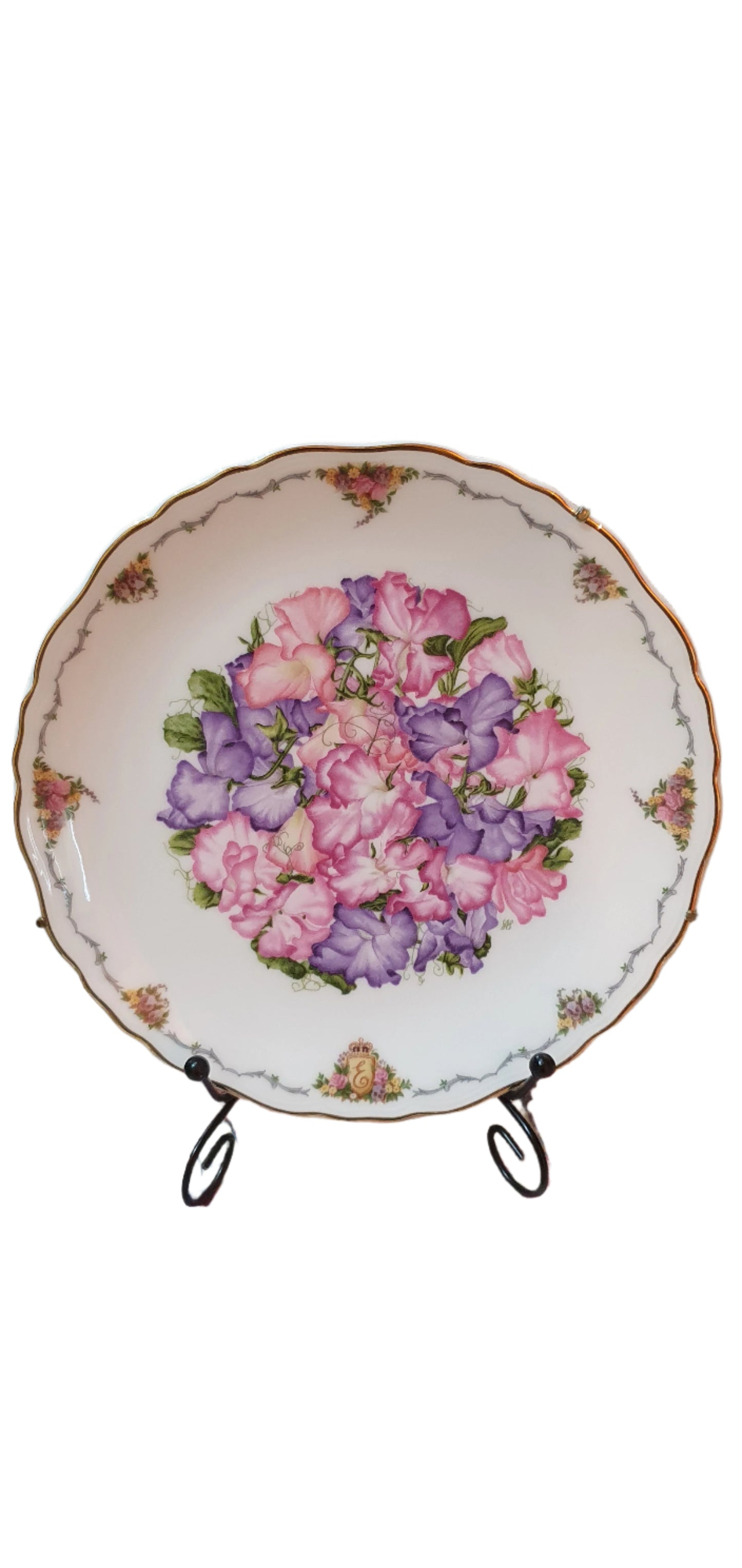 Decorative collectible porcelain plates from Royal Albert, part of "The Queen Mother's Favorite Flowers" series.